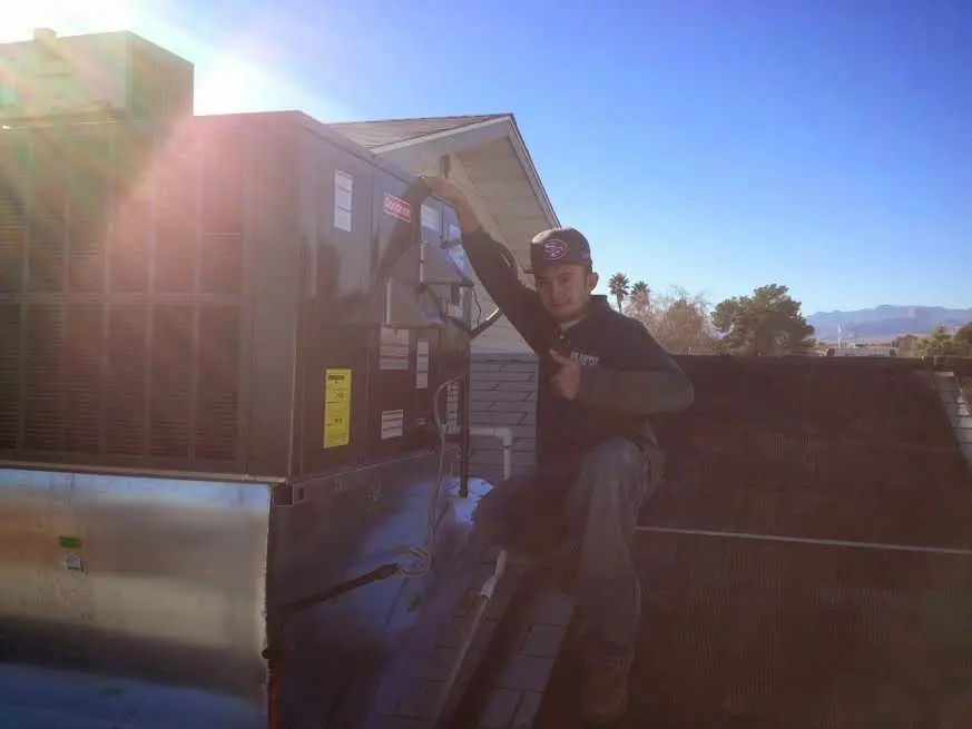 HVAC technician performing Heat Pump Repair on a rooftop unit in North Augusta